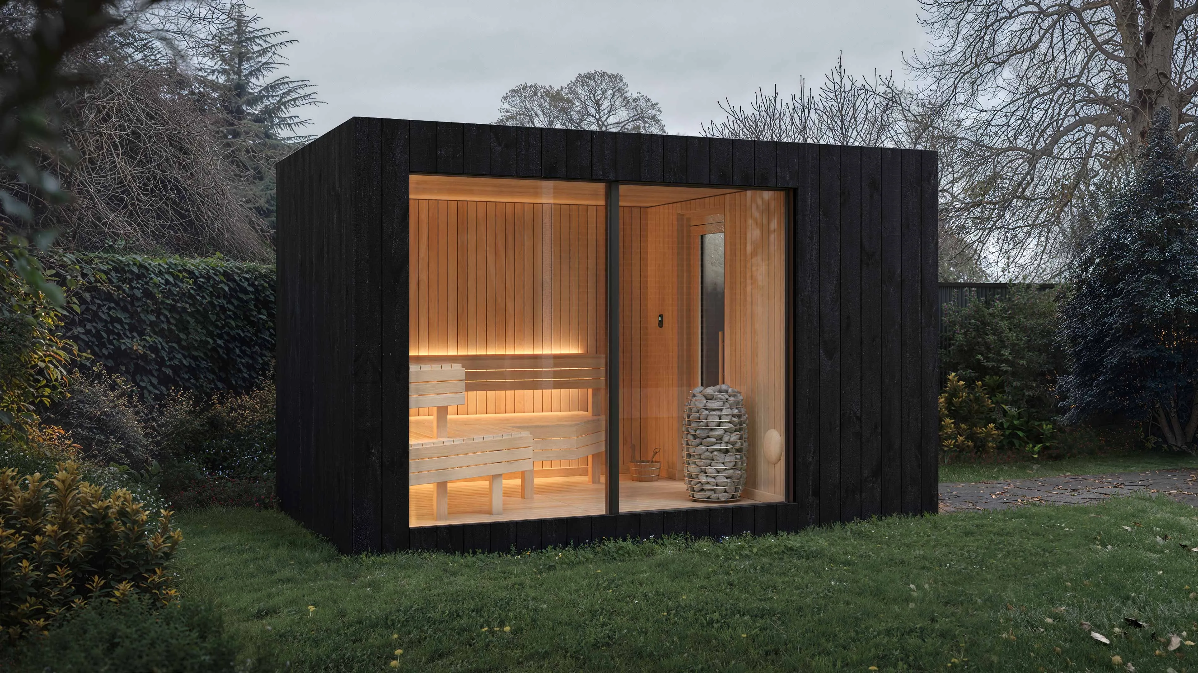 The NOOK Sauna glowing at dusk in a walled garden